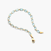 Oval Blue Topaz Tennis Bracelet in Yellow Gold